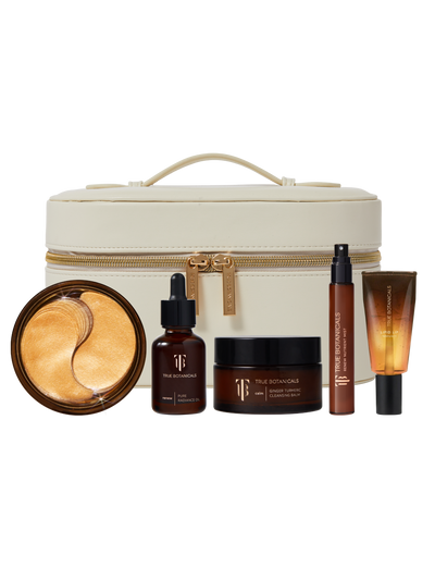 Skincare product set with a cream-colored travel case on a white background