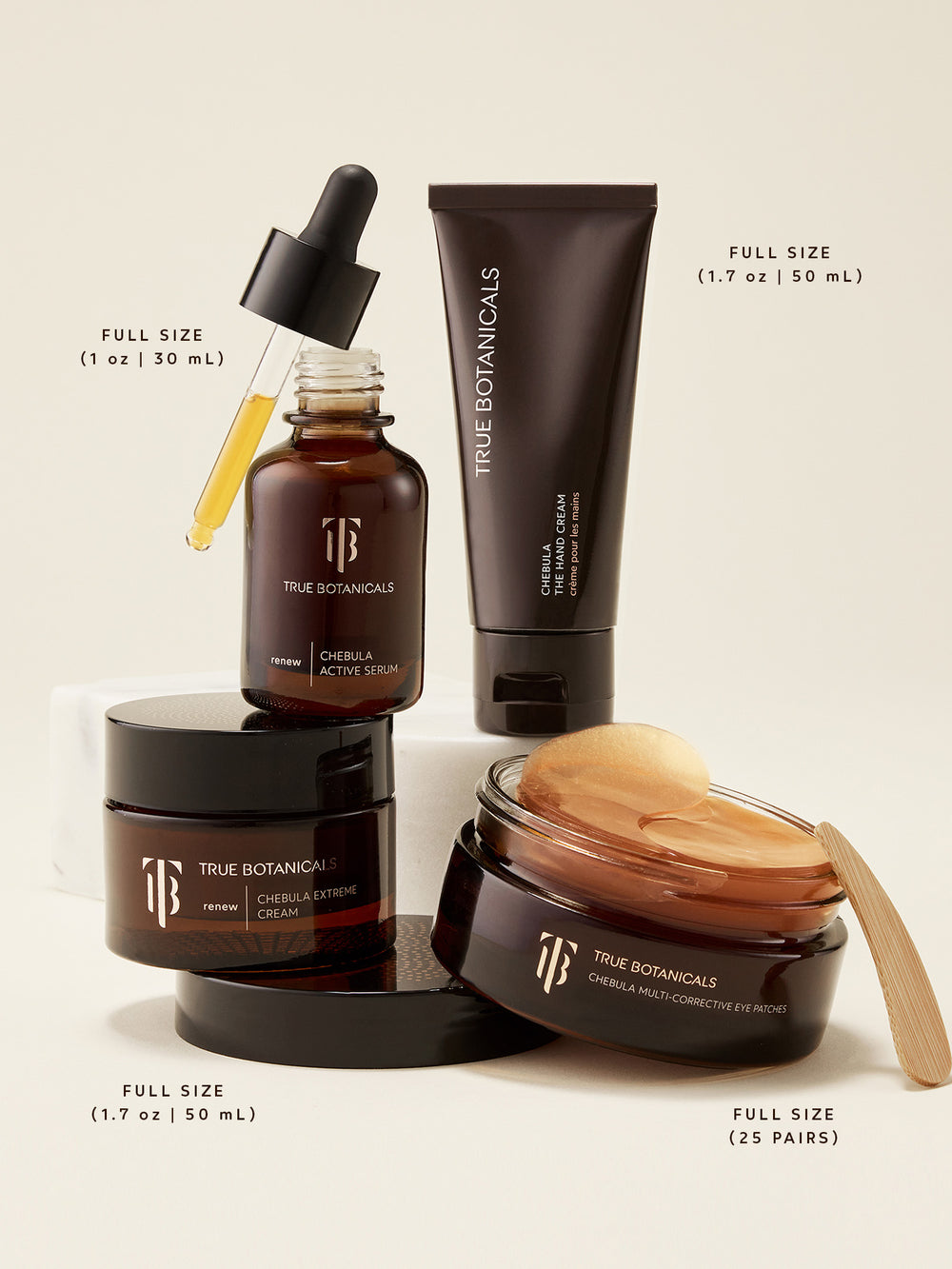 A complete lineup of True Botanicals Chebula-powered skincare in full sizes, including Chebula Active Serum (1 oz | 30 mL), Chebula Extreme Cream (1.7 oz | 50 mL), Chebula Eye Cream (1.7 oz | 50 mL), and Chebula Multi-Corrective Eye Patches (25 pairs). Displayed on a soft neutral background with visible textures and gold-toned patches, this image highlights high-performance formulas designed to target signs of aging, dryness, and dullness with clinically proven results.