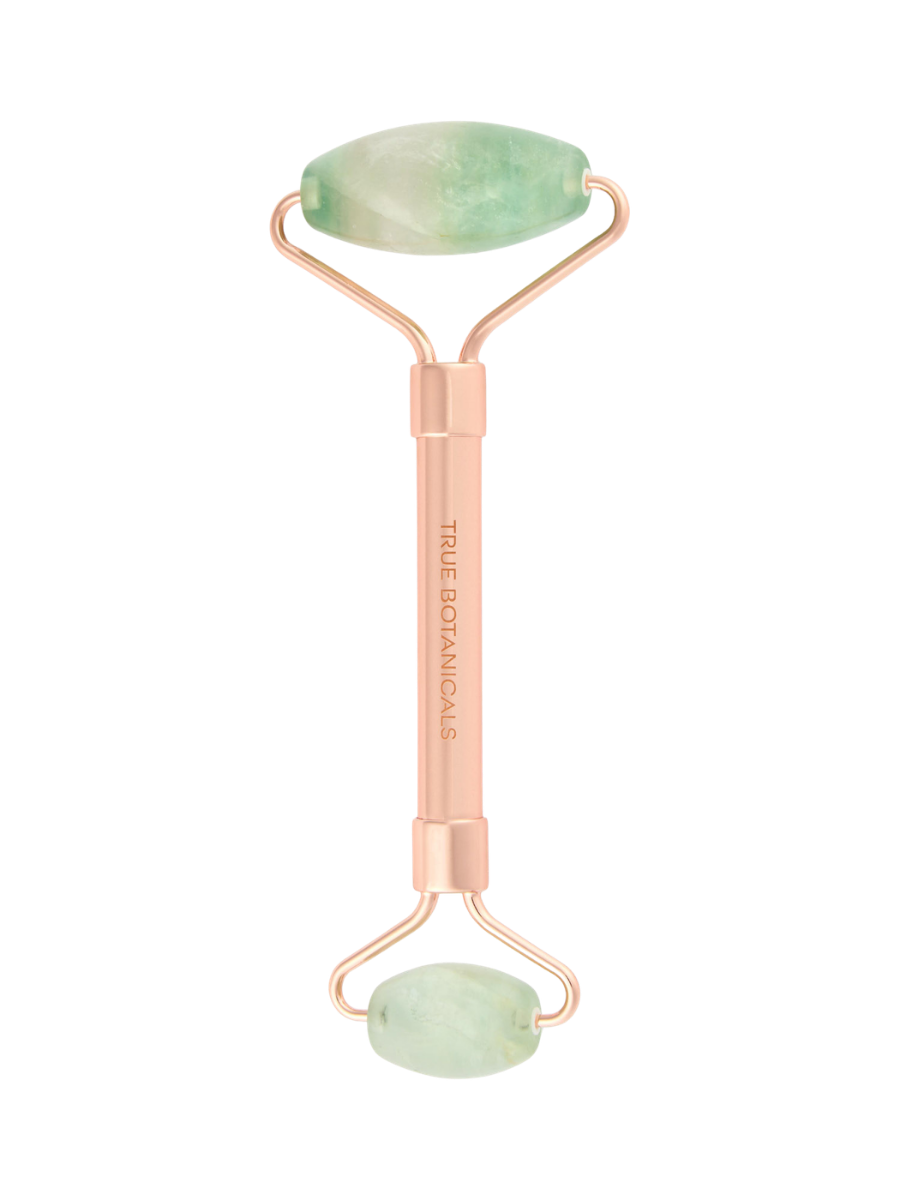 Beauty roller with jade stones on a white background