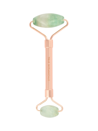 Beauty roller with jade stones on a white background