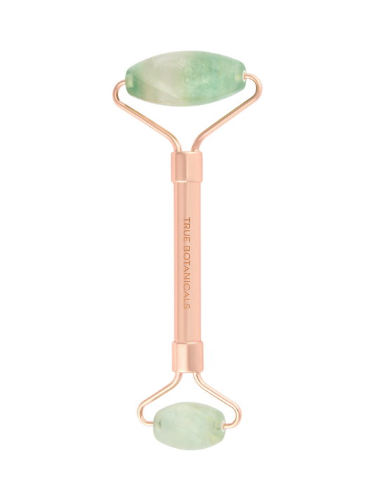 Beauty roller with jade stones on a white background