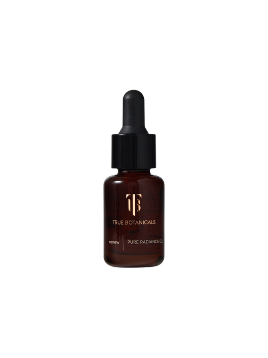 True Botanicals Renew Pure Radiance Oil travel size 15mL deep amber glass dropper bottle with a black rubber bulb top and gold logo, shown on a transparent background.
